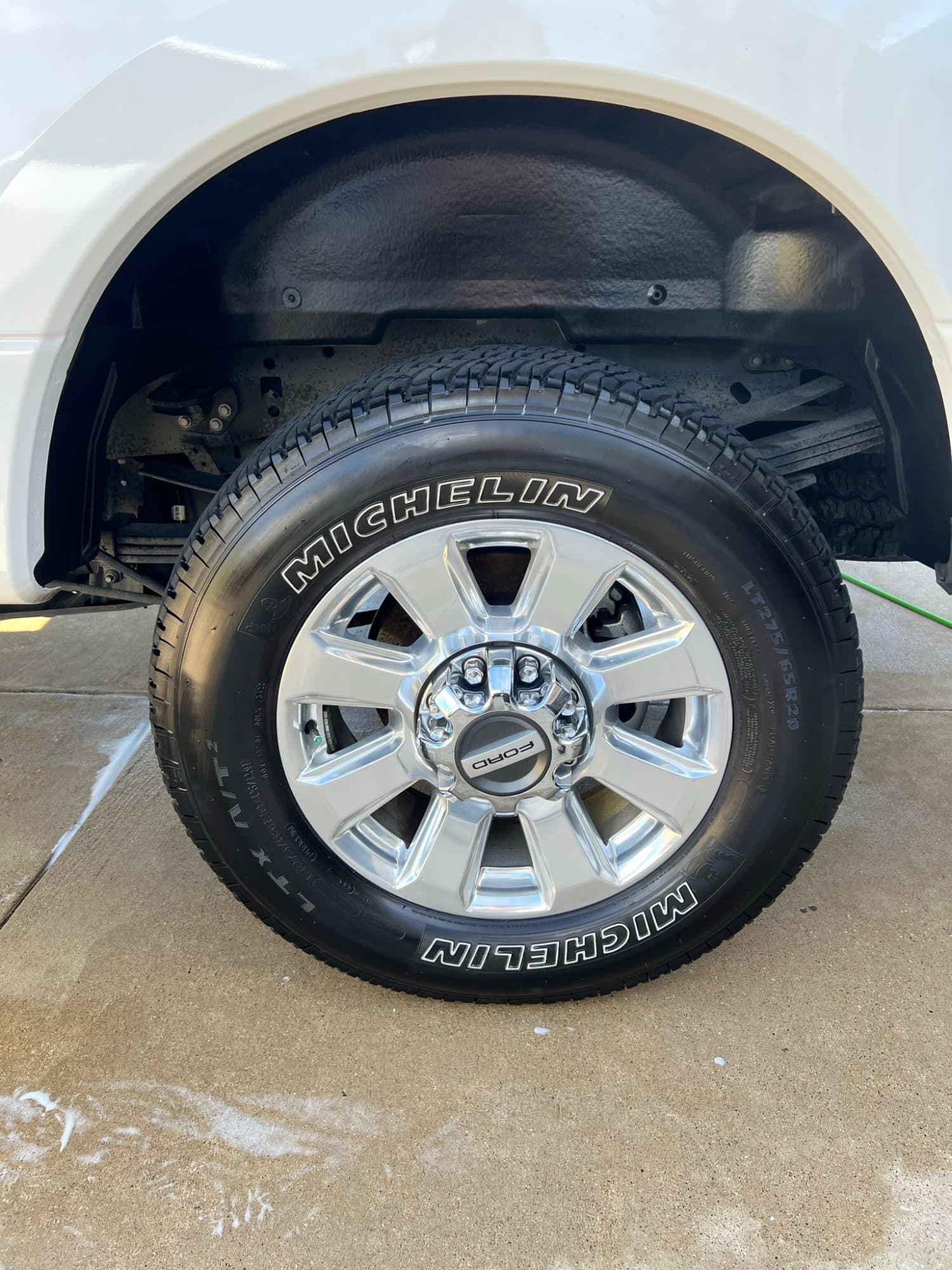 Chrome Ford wheel and tire detail with Michelin tires